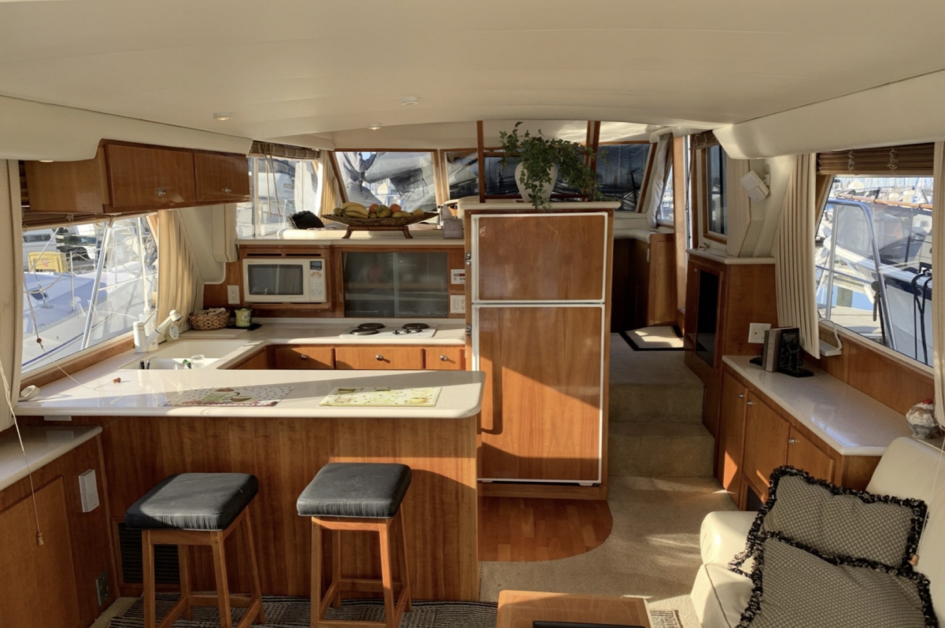 Main salon and galley with wood paneling and bar stools